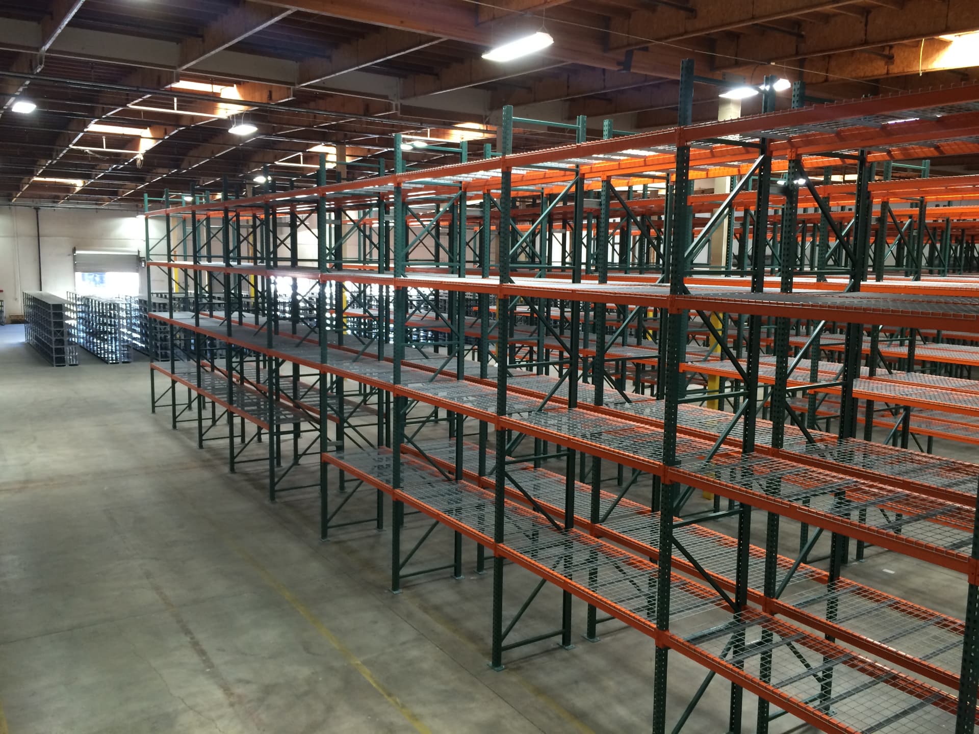 Wide view of pallet rack rows across a warehouse floor